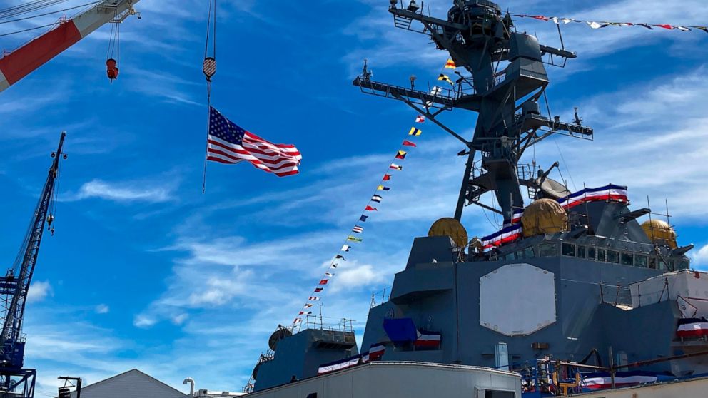 The superstructure of the future USS Basilone and a crane are seen on Saturday, June 18, at Bath Iron Works in Bath, Maine. The christening of a Navy destroyer on Saturday highlighted the sacrifices of two generations — the ship’s namesake killed in 