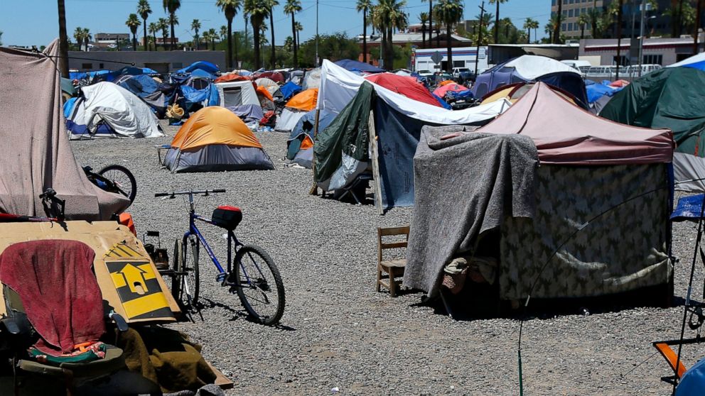 FILE - A large homeless encampment is shown in Phoenix, Aug. 5, 2020. On Wednesday, Nov. 30, 2022, the ACLU of Arizona filed a complaint against the city of Phoenix to block the planned resumption of cleanup sweeps it says have displaced people and d