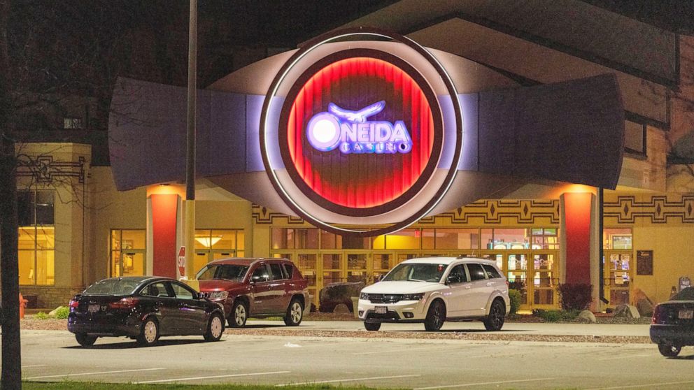 The Oneida Casino lights glow in the parking lot in the early morning hours of Sunday, May 2nd, 2021, near Green Bay, Wisconsin. Authorities in Wisconsin say a gunman killed two people at a Green Bay casino restaurant and seriously wounded a third be