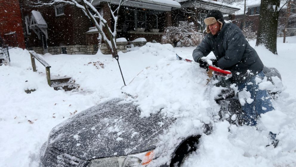 Jeff Clifford digs out his girlfriend's car from a pile of snow on Saturday, Jan. 12, 2019, in St. Louis. A winter storm swept the region this weekend, snarling traffic in several states and leaving thousands without power. (Laurie Skrivan/St. Louis 