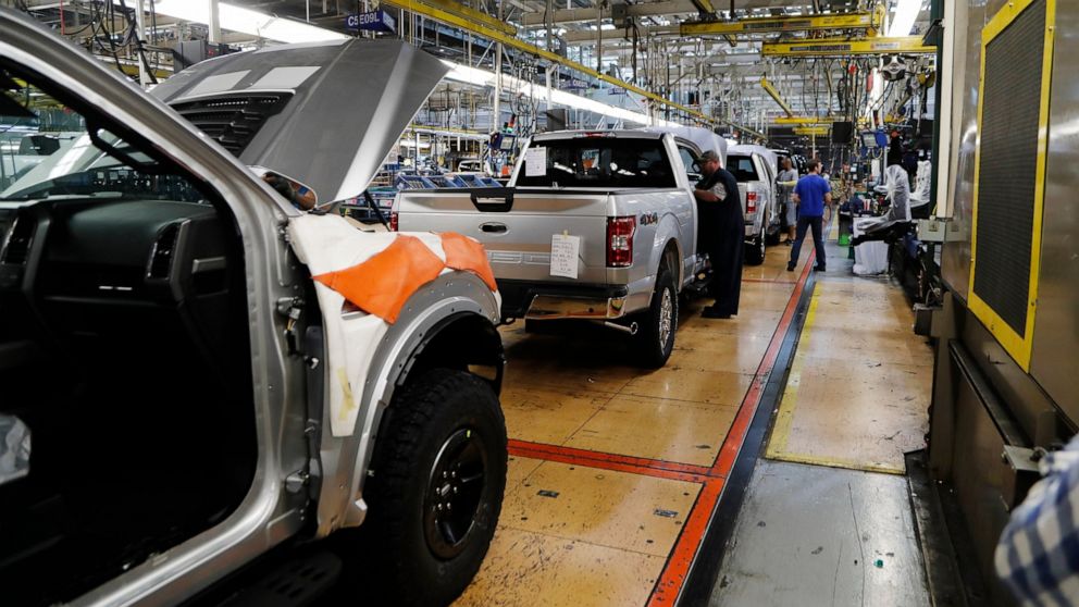 FILE - In this Sept. 27, 2018, file photo a United Auto Workers assemblyman works on a 2018 Ford F-150 truck being assembled at the Ford Rouge assembly plant in Dearborn, Mich. Ford is recalling its popular F-150 pickup truck in Canada to fix a probl