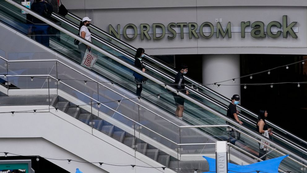 People wear face masks as they shop at the Nordstrom Local DTLA downtown Los Angeles on Tuesday, March 15, 2022. Inflation is at a 40-year high. Stock prices are sinking. The Federal Reserve is making borrowing much costlier. Home sales are down, and