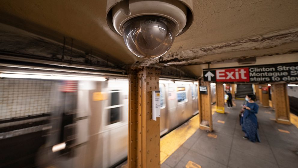 FILE - A video surveillance camera hangs from the ceiling above a subway platform, Wednesday, Oct. 7, 2020 in the Brooklyn borough of New York. All subway cars in New York will soon be equipped with security cameras in an effort to keep riders safe a