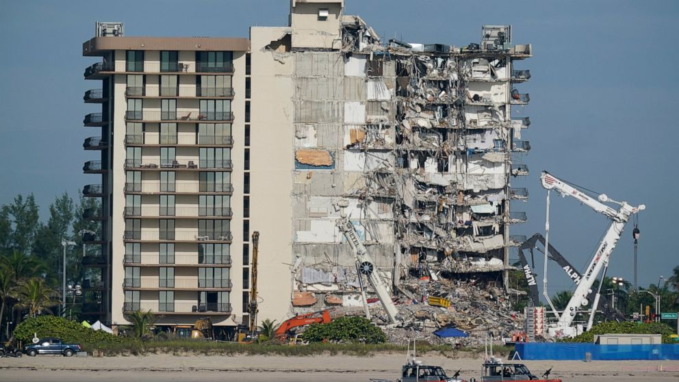 FILE - Coast Guard boats patrol in front of the partially collapsed Champlain Towers South condo building, July 1, 2021, in Surfside, Fla. A nearly $1 billion tentative settlement has been reached in a class-action lawsuit brought by families of vict