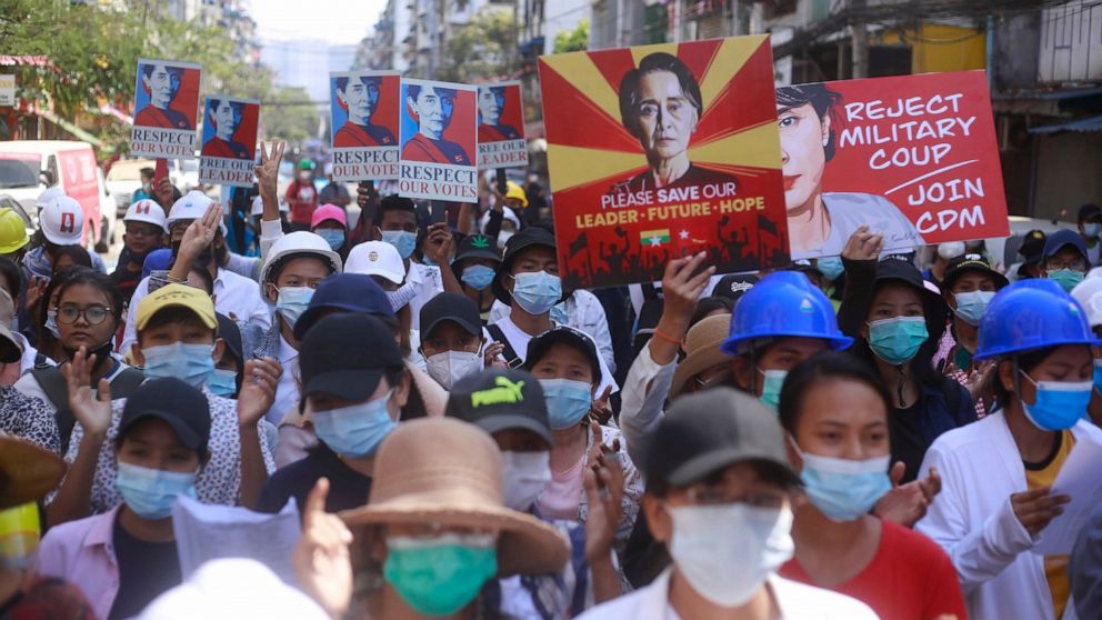 Anti-coup protesters hold up images of deposed leader Aung San Suu Kyi as they gather in Yangon, Myanmar, Friday, Mar. 5, 2021. Demonstrators defy growing violence by security forces and stage more anti-coup protests ahead of a special U.N. Security 