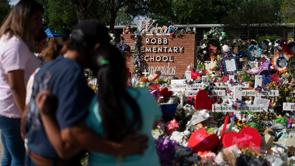 FILE - People visit a memorial at Robb Elementary School in Uvalde, Texas, on June 2, 2022, to pay their respects to the victims killed in a school shooting. A legislative committee investigating the deadly shooting at the Texas elementary school is 