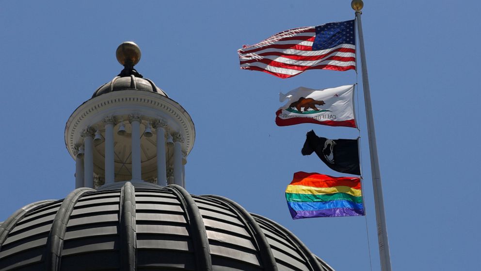 The rainbow Pride flag flutters from the flag pole at the state Capitol in Sacramento, Calif., Monday, June 17, 2019. California's governor has signed a law he says will help military service members who were discharged under "don't ask, don't tell" 