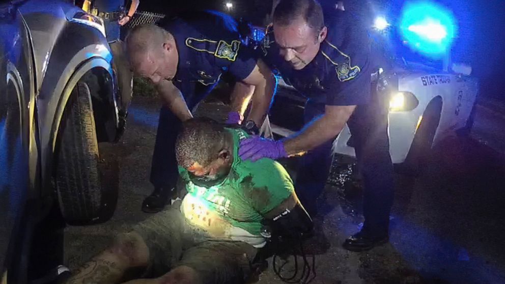 FILE - This image from the body camera video of Louisiana State Police Trooper Dakota DeMoss shows his colleagues, Kory York, center left, and Chris Hollingsworth, center right, holding up Ronald Greene before paramedics arrived on May 10, 2019, outs