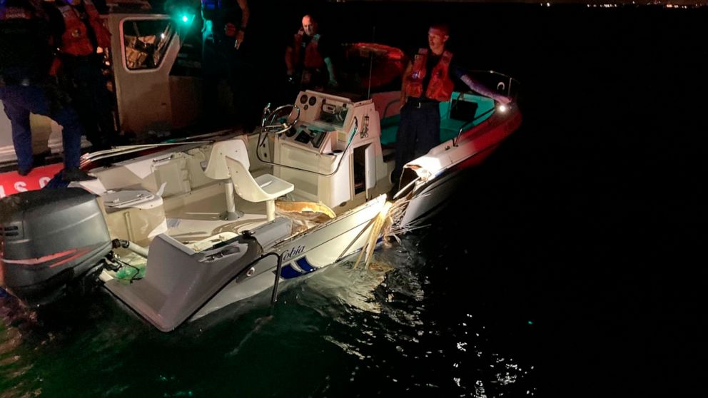 In this image provided by the U.S. Coast Guard, a Coast Guard Station Miami Beach small boat crew inspects a boat that was part of a collision near Key Biscayne, Fla., late Friday, June 17, 2022. The Coast Guard, Miami-Dade Fire Rescue, Miami-Dade Po
