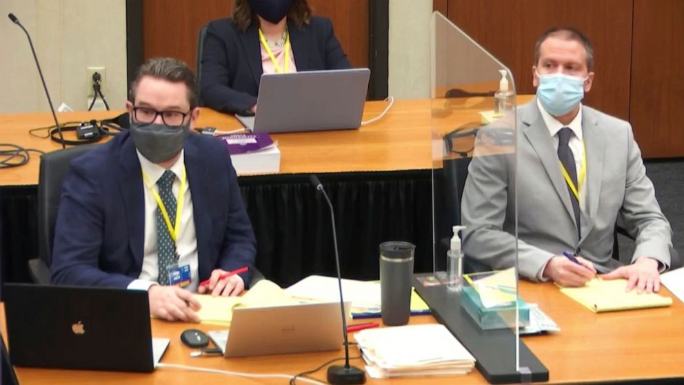 In this image from video, defense attorney Eric Nelson, left, and defendant former Minneapolis police Officer Derek Chauvin listen as Assistant Minnesota Attorney General Matthew Frank, questions witness Christopher Martin as Hennepin County Judge Pe