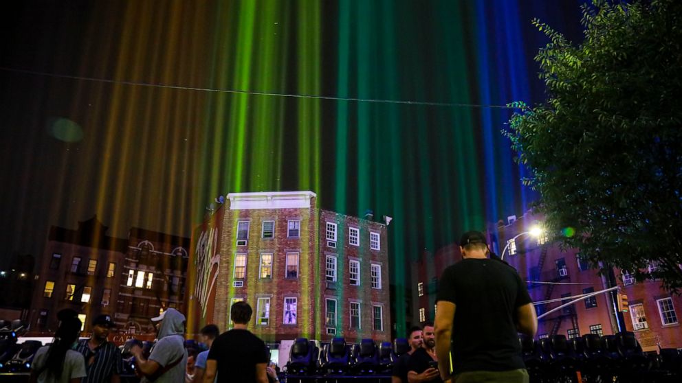 A rainbow light display illuminates the night sky in the West Village near The Stonewall Inn, birthplace of the gay rights movement, Saturday, June 27, 2020, in New York. The light installation was presented by Kind snack foods to mark what would hav