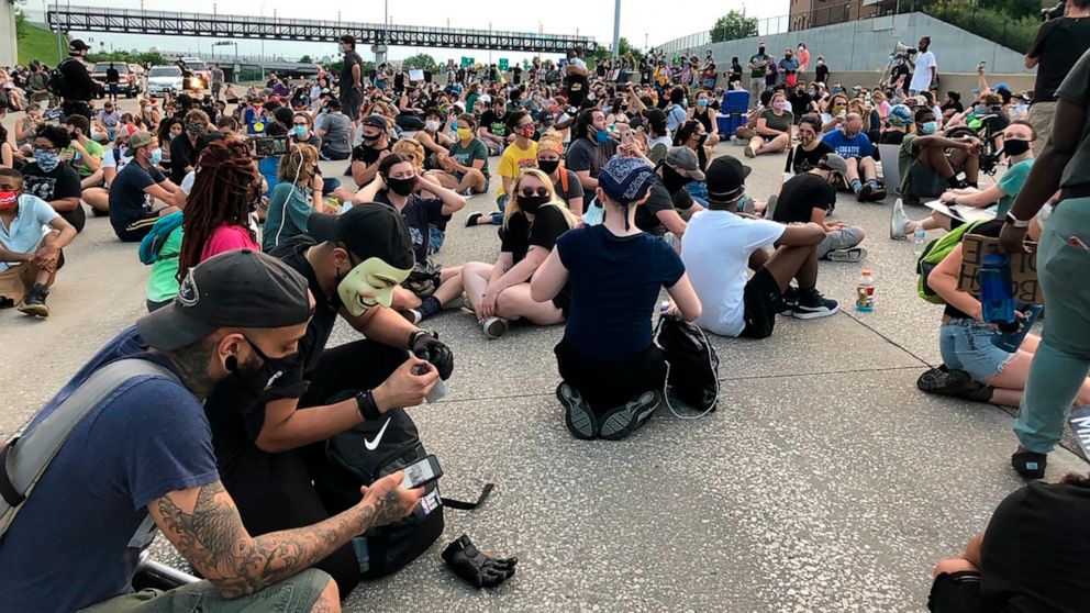 Protesters sit on Interstate 64 in St. Louis for several moments, Friday, July 3, 2020, in memory of George Floyd. The protest, the latest organized by the group Expect Us, was among several protests in the weeks since Floyd's death in Minneapolis re
