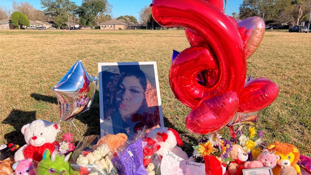 A makeshift memorial sits near the side of a street, Thursday, Jan 13, 2022, in Houston, next to a large grassy area where Diamond Alvarez was fatally shot. Police continue looking for who fatally shot the 16-year-old Houston girl as she walked her d