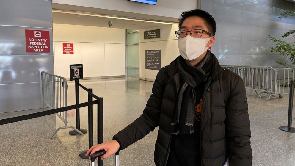 Fever alarms, paranoia as masked passengers fly from China thumbnail