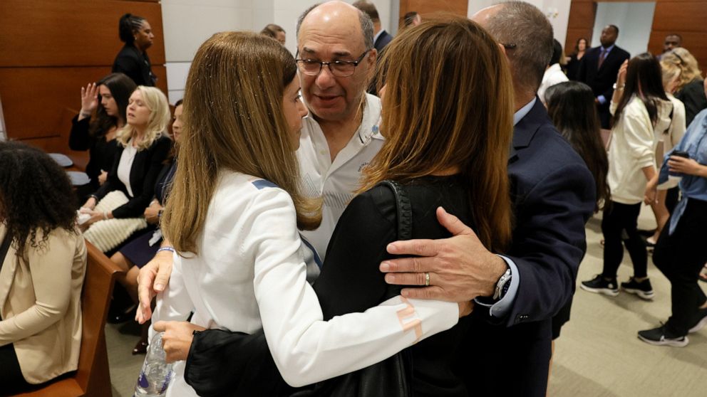 Linda Beigel Schulman, Michael Schulman, Patricia Padauy Oliver and Fred Guttenberg, families of the victims, embrace in the courtroom while waiting for an expected verdict in the penalty phase of the trial of Marjory Stoneman Douglas High School sho