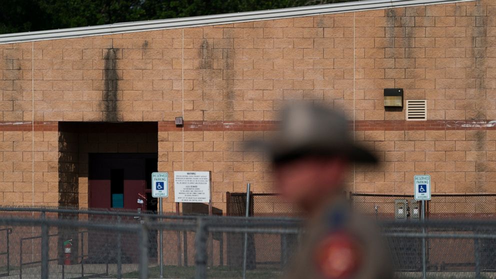 A back door at Robb Elementary School, where a gunman entered through to get into a classroom in last week's shooting, is seen in the distance in Uvalde, Texas, Monday, May 30, 2022. (AP Photo/Jae C. Hong)