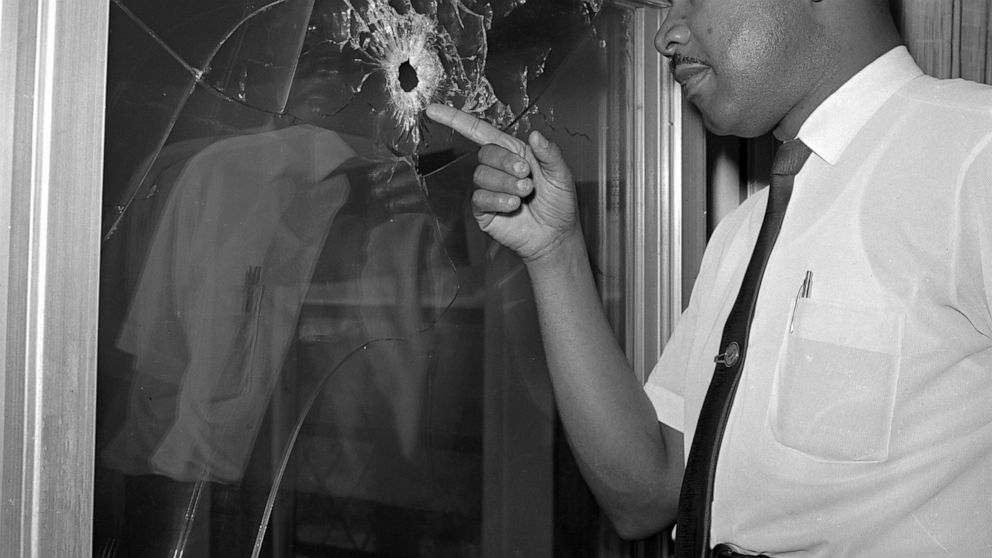 FILE - In this June 5, 1964, file photo, Dr. Martin Luther King Jr. looks at a glass door of his rented beach cottage in St. Augustine, Fla., that was shot into. The house connected to King is now in the hands of a couple who plans to preserve it. Da