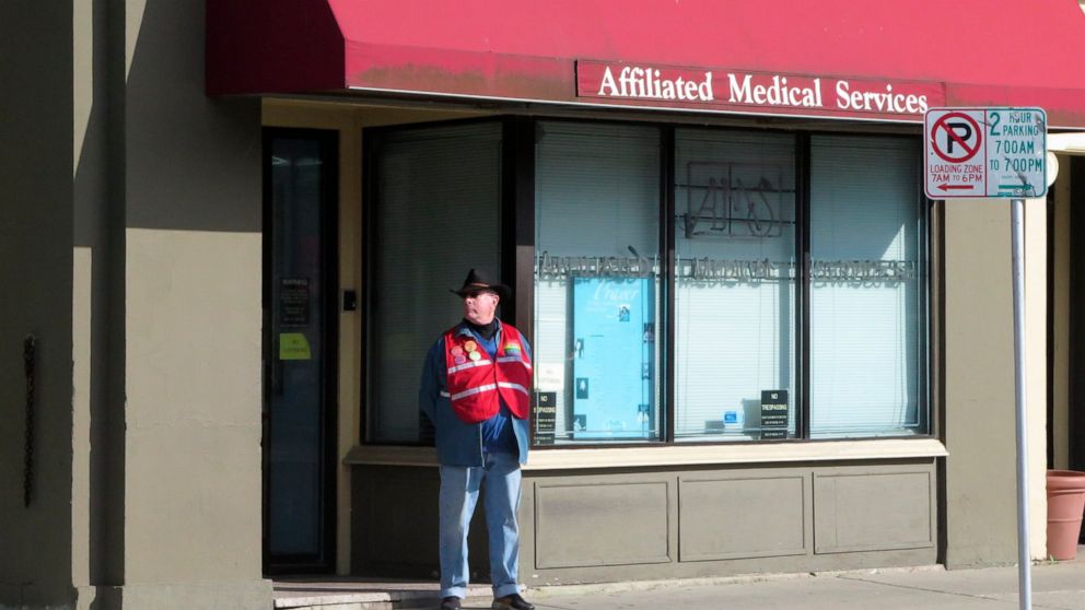 FILE - A volunteer escort outside Affiliated Medical Services, a Milwaukee abortion clinic, on Wednesday, May 28, 2014, in Milwaukee. Abortion providers are bracing for the final days of the U.S. Supreme Court's guarantee of a right to an abortion by