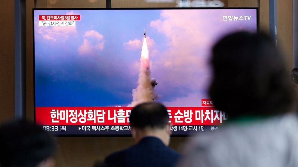 People watch a TV screen showing a news program reporting about North Korea's missile launch with file image, at a train station in Seoul, South Korea, Wednesday, May 25, 2022. North Korea launched three ballistic missiles toward the sea on Wednesday