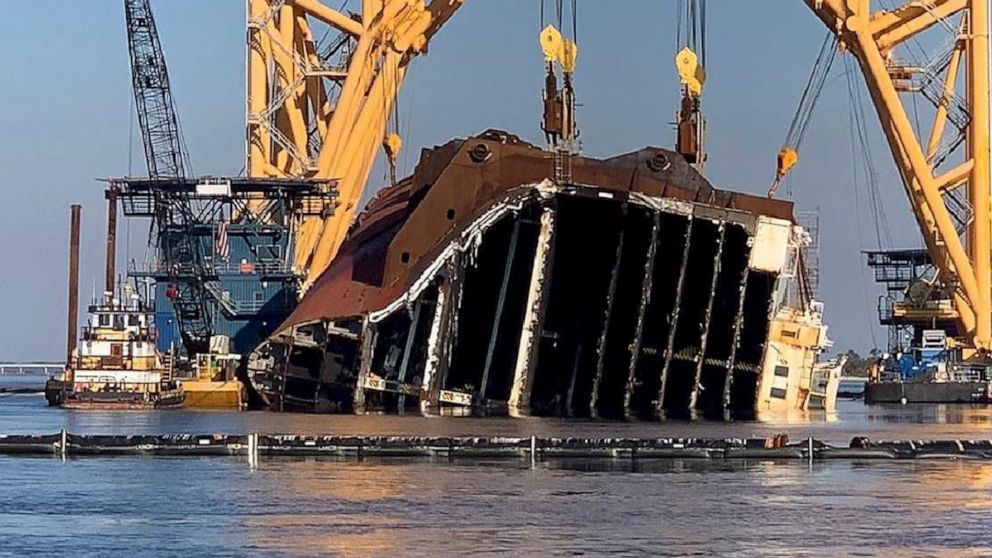 In this Feb. 25, 2021 photo, a towering crane straddles the capsized cargo ship Golden Ray, its interior decks exposed after the ship's bow was cut off and hauled away, off the coast of St. Simons Island, Ga. Salvage crews began Nov. 6 cutting the sh