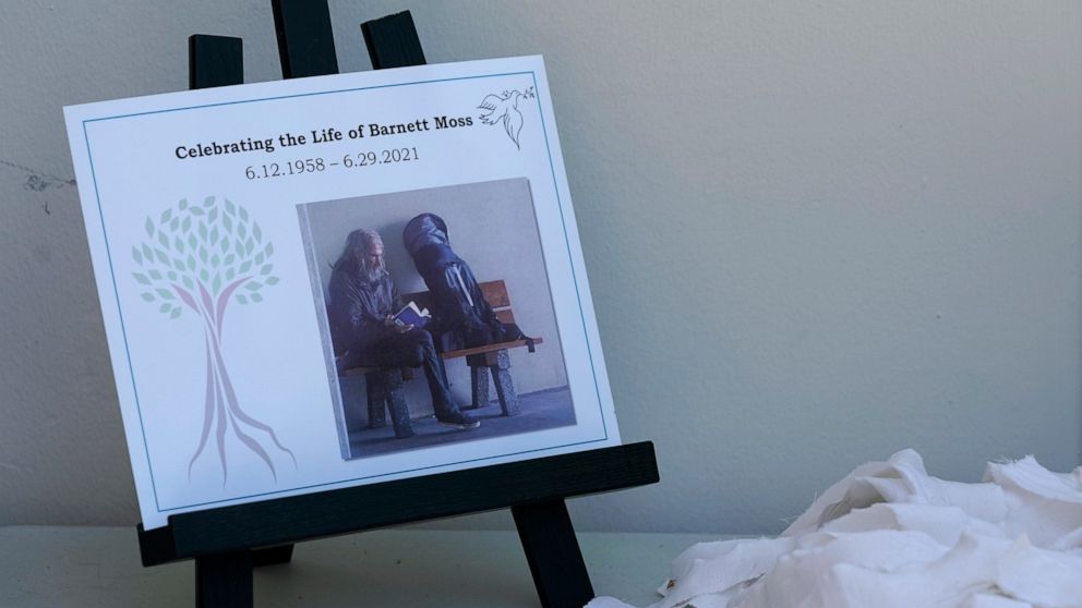 A flyer that reads "Celebrating the Life of Barnett Moss" is displayed during a memorial service for Moss — who died last week during the Pacific Northwest Heatwave — on the front porch entryway of the United Churches of Olympia, Friday, July 9, 2021