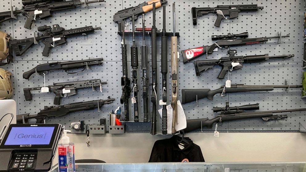 FILE - Firearms are displayed at a gun shop in Salem, Ore., on Feb. 19, 2021. An Oregon judge on Tuesday, Dec. 13, 2022, extended an earlier order blocking a key part of a new, voter-approved gun law and was hearing lengthy arguments on whether to al