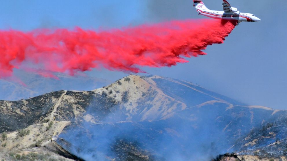 FILE - In this April 28, 2021, file photo, a fixed-wing tanker makes a drop of fire retardant on the North Fire in Castaic, Calif. By aggressively responding to smaller fire, officials said Thursday, May 13, 2021, they hope to minimize the number of 