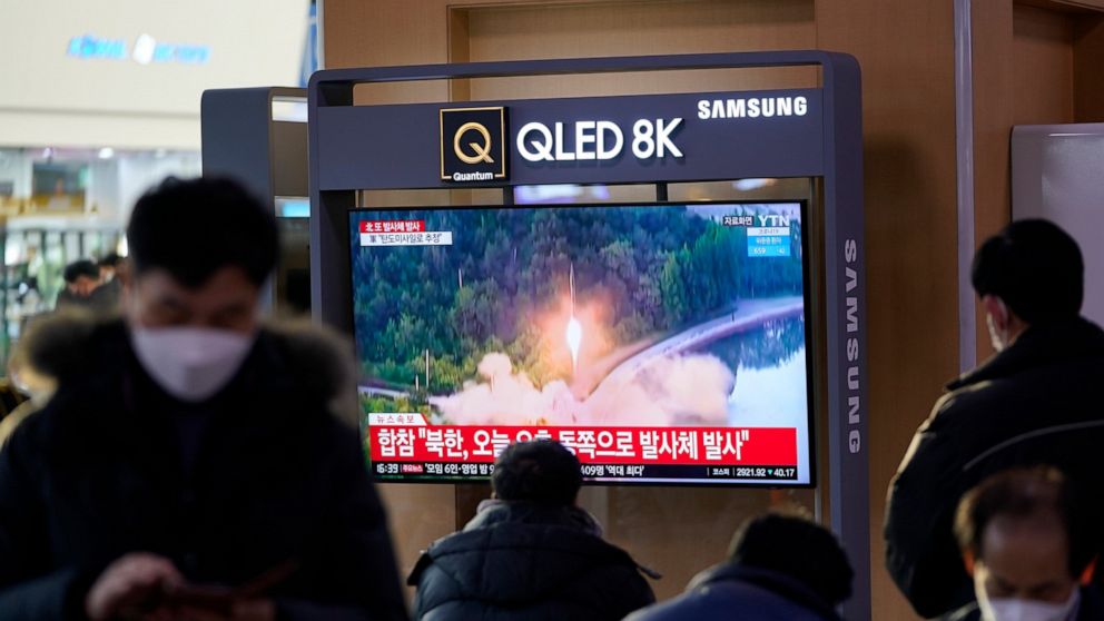 People watch a TV screen showing a news program reporting about North Korea's missile launch with a file footage, at a train station in Seoul, South Korea, Friday, Jan. 14, 2022. North Korea on Friday fired two short-range ballistic missiles in its t