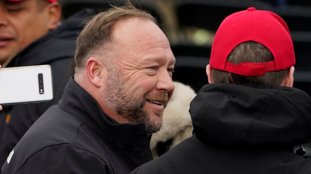 FILE - Alex Jones, left, attends a rally in support of President Donald Trump called the "Save America Rally," Wednesday, Jan. 6, 2021, in Washington. The wife of the conspiracy theorist was arrested Friday, Dec. 24, 2021, Christmas Eve on a domestic