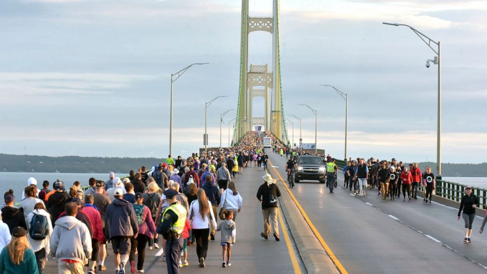 FILE - In a Sept. 2, 2019, file photo, pedestrians walk the Mackinac Bridge on during the 62nd annual Labor Day Bridge Walk in Mackinaw City, Mich. A bomb scare closed the bridge connecting Michigan’s two peninsulas for about three hours on Sunday af