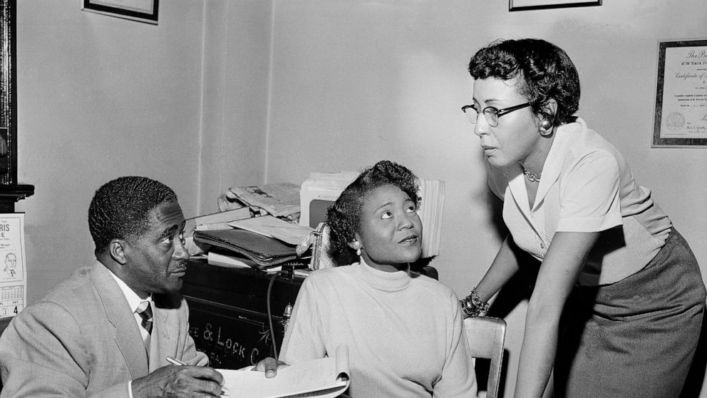 FILE - This file photo shows Autherine Lucy Foster, center, the first Black person to attend University of Alabama, discussing her return to campus following mob demonstrations in Birmingham, Ala., on Feb. 7, 1956. She held a press conference accompa