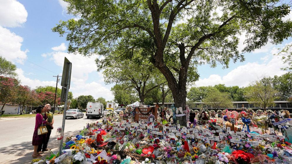 Pecan trees, planted in the 1960's, shade a memorial created to honor the victims killed in the recent school shooting at Robb Elementary, Thursday, June 9, 2022, in Uvalde, Texas. The Texas elementary school where a gunman killed 19 children and two