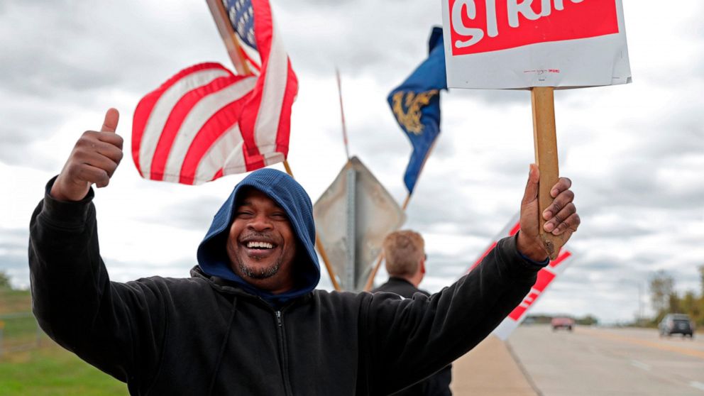 Bill Jackson, of St. Louis, gives a thumbs up to drivers that wave or honk as United Auto Workers outside the GM Wentzville Assembly Center in Wentzville, Mo., Wednesday, Oct. 16, 2019. UAW workers have been on strike since Sept. 16, but have reached