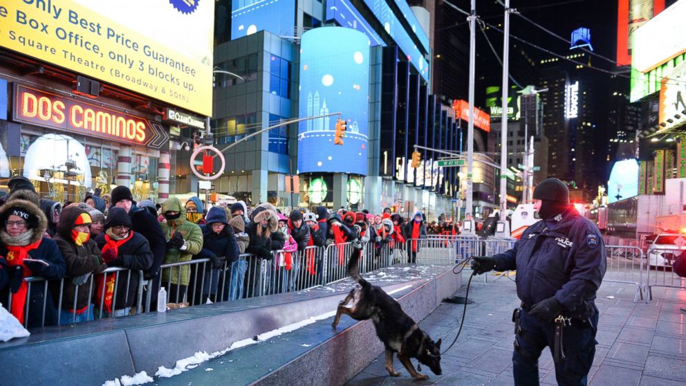 FILE - In this Dec. 31, 2017, file photo, a police K-9 unit patrols in New York's Times Square where crowds were gathered for the annual New Year's Eve celebration. The New York Police Department is adding a drone this year to the security forces it 