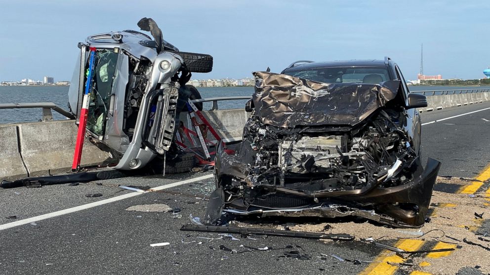 This photo provided by the Ocean City Fire Department shows the wreckage from a car accident on the Route 90 bridge in Ocean City, Md., on Sunday, May 2, 2021. A bystander jumped over a highway guard rail and into a Maryland bay Sunday to rescue a ch