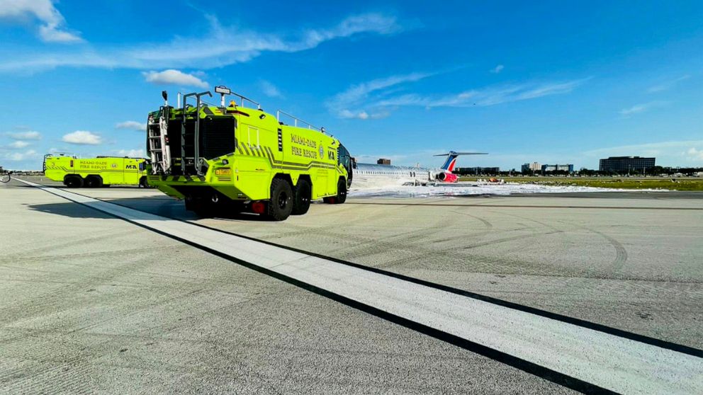 In this photo released by the Miami-Dade Fire Rescue Department, Miami-Dade Fire Rescue crews works at the scene of an aircraft fire at Miami International Airport, Tuesday, June 21, 2022. Authorities said a plane carrying 126 people caught fire afte