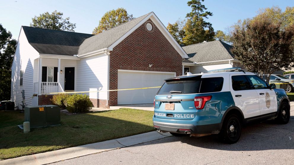 A police officer remains in front of the house where the suspected shooter lived on Sahalee Way following a shooting in Raleigh, N.C., Friday, Oct. 14, 2022. Several people were shot and killed by a gunman in the neighborhood Thursday night, Oct. 13.