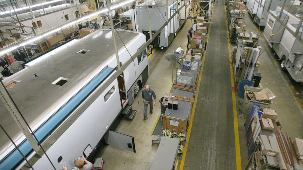 FILE - In this Oct. 13, 2013, file photo, workers assemble recreational vehicles at Winebago Industries in Forest City, Iowa. Winnebago Industries is moving its corporate headquarters from Iowa to Minnesota, the company said in a statement. Based in 