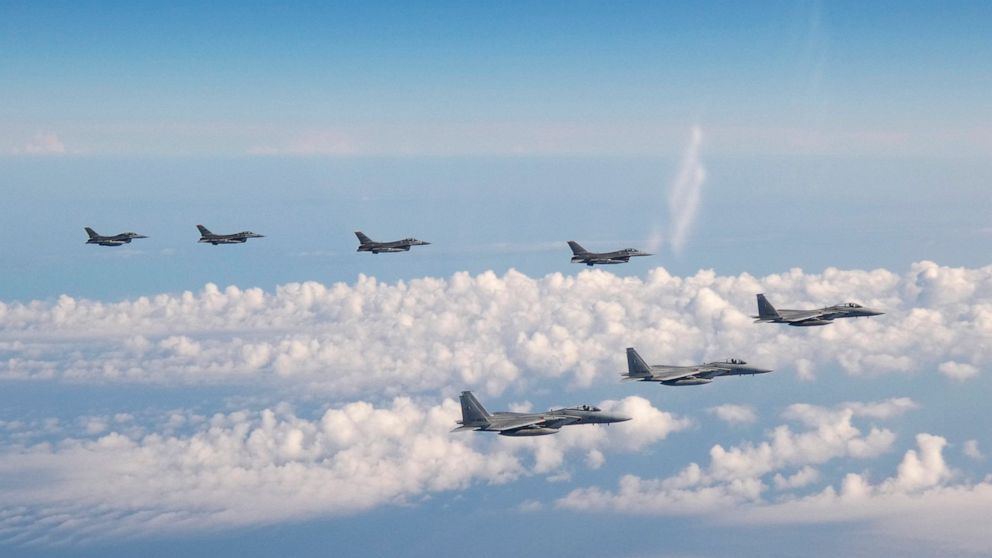 In this photo provided by the Joint Staff of the Japanese Self-Defense Force, three F-15 warplanes of the Japanese Self-Defense Force, front, and four F-16 fighters of the U.S. Armed Forces fly over the Sea of Japan on Wednesday, May 25, 2022. Japane