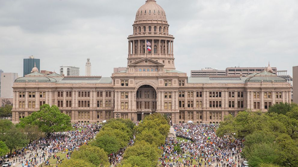 FILE - In this March 24, 2018, file photo, thousands of people gather on the grounds of the Texas State Capitol during a "March for Our Lives" rally in Austin, Texas. The vast majority of mass shooters have acquired their firearms legally with nothin