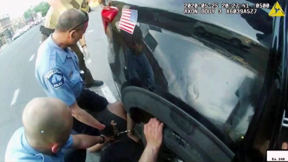 FILE - In this image from police body camera video shown as evidence in court, paramedics arrive as Minneapolis police officers, including Derick Chauvin, second from left, and J. Alexander Kueng restrain George Floyd in Minneapolis, on May 25, 2020.