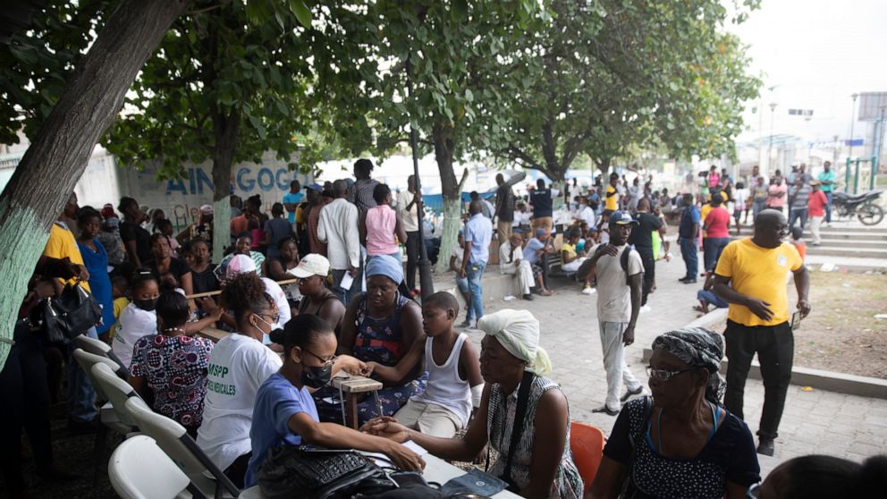 FILE - Residents who were displaced from their homes due to clashes between armed gangs in La Plaine, are examined at a mobile medical clinic in the Tabare neighborhood of Port-au-Prince, Haiti, May 13, 2022. Close to 60% of Haiti’s capital is domina
