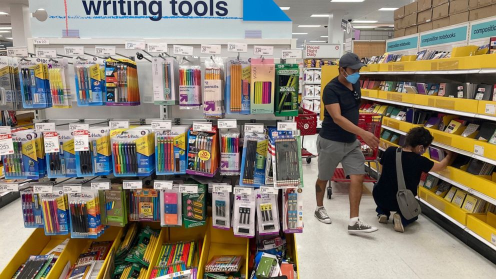 FILE - Shoppers look for school supplies at a store, Wednesday, July 27, 2022, in South Miami, Fla. Economists are saying strong consumer demand, spurred by rising wages, is fueling inflation. (AP Photo/Marta Lavandier, File)