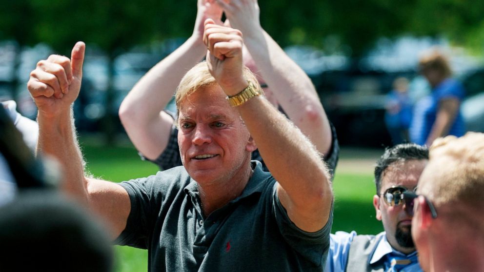 FILE - In an Aug. 12, 2017, file photo, David Duke arrives to give remarks after a white nationalist protest was declared an unlawful assembly, in Charlottesville, Va. Duke, a former Ku Klux Klan leader, has agreed to pay Bill Burke, of Athens, Ohio,