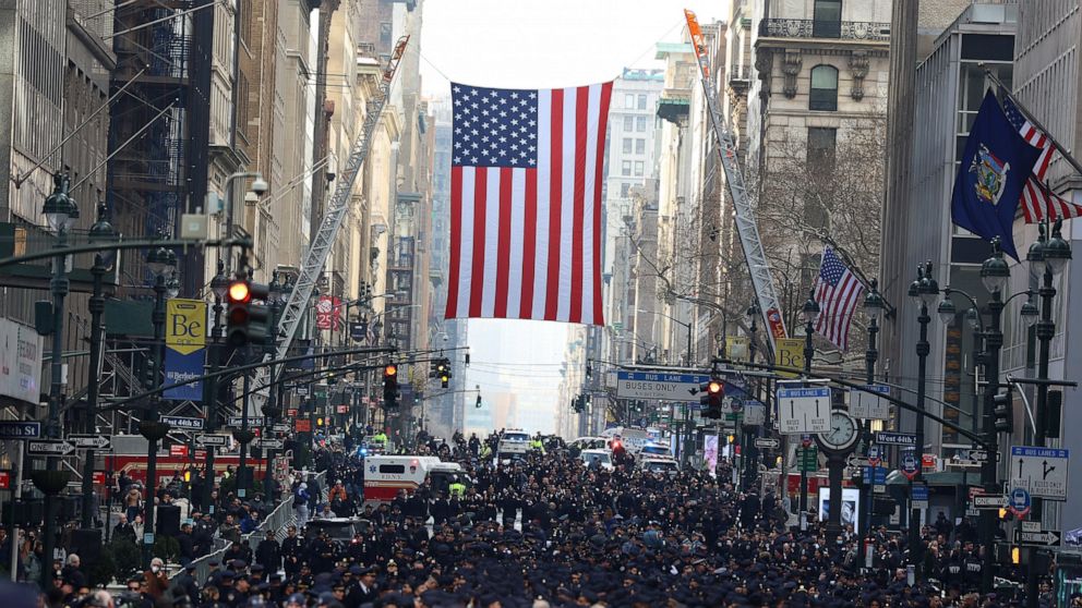 New York Police officers begin to arrive along Fifth Avenue outside St. Patrick's Cathedral for Officer Wilbert Mora's funeral, Wednesday, Feb. 2, 2022, in New York. For the second time in under a week, police converged on New York City's St. Patrick