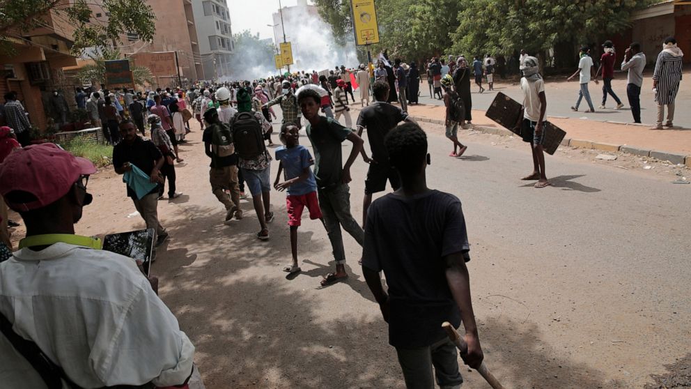 Protesters clash with security forces as they fire teargas to prevent them from marching towards the presidential palace during demonstrations demanding civilian rule, in Khartoum, Sudan, Thursday, May 19, 2022. (AP Photo/Marwan Ali)