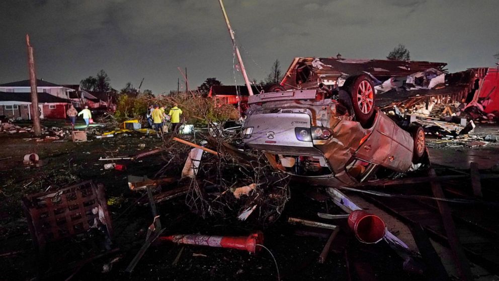 FILE - A car is flipped over after a tornado tore through the area in Arabi, La., Tuesday, March 22, 2022, in a part of the city that had been heavily damaged by Hurricane Katrina 17 years earlier. A United Nations report released on Monday, April 25