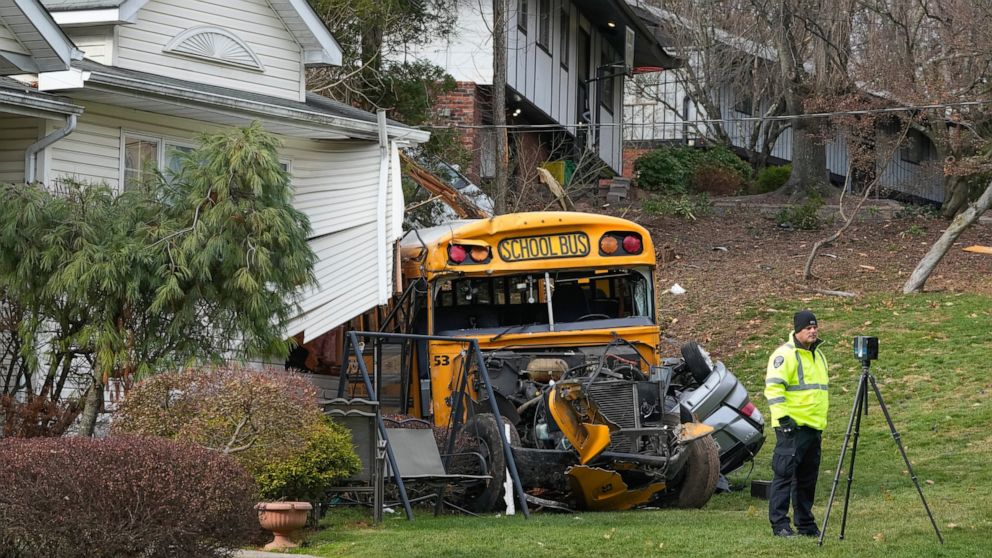 A school bus involved in an accident is seen in the village of New Hempstead in Rockland County, N.Y., Thursday, Dec. 1, 2022. Multiple injuries were reported Thursday when a school bus crashed into a house and another vehicle in a suburb north of Ne