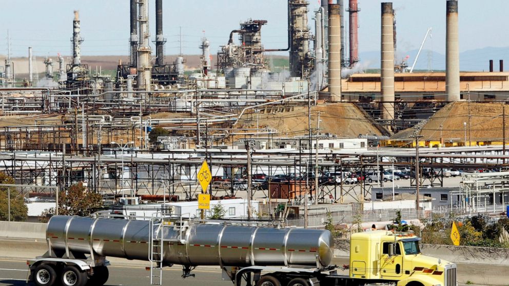 FILE - A tanker truck passes the Chevron oil refinery in Richmond, Calif., on March 9, 2010. More than 500 workers at the Chevron Corp. refinery in the San Francisco Bay area have told the company they will go on strike at 12:01 a.m. Monday, March 21