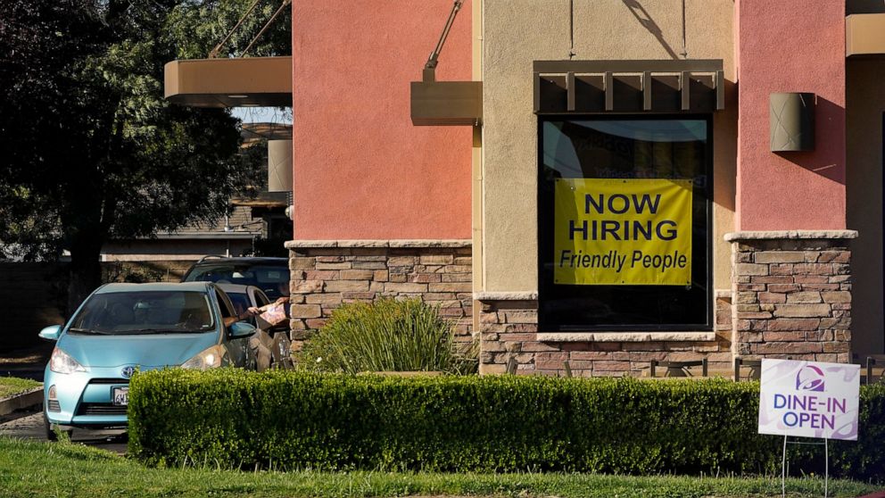 A hiring sign hangs in the window of a Taco Bell in Sacramento, Calif., Thursday, July 15, 2021. Hiring in California slowed down in June as the unemployment rate held steady at 7.7% according to new numbers released on Friday, July 16, 2021 by the E